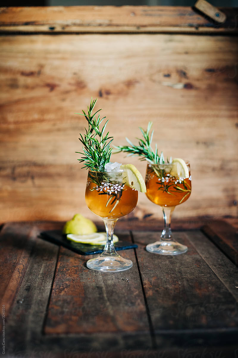 Rosemary gin fizz cocktail on wooden background