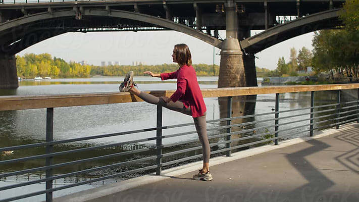 A Woman Folds And Unwraps A Yoga Mat by Stocksy Contributor Tatiana  Timofeeva - Stocksy