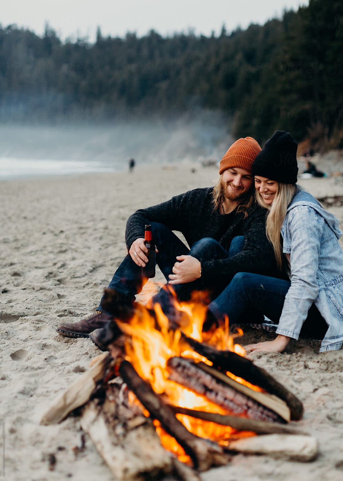 beach bonfire and happy couple