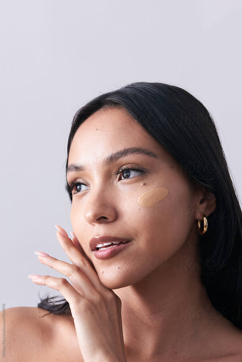 Young Woman with Makeup Cosmetics Foundation Swatch on Face