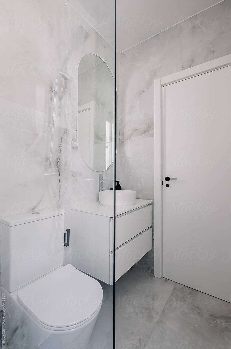 modern and clean bathroom decorated with white marble walls