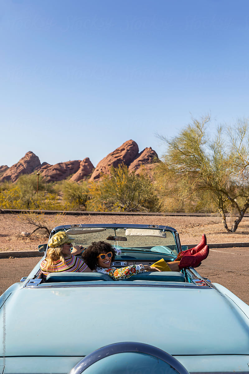 Happy Friends Relaxing in Vintage car on road trip