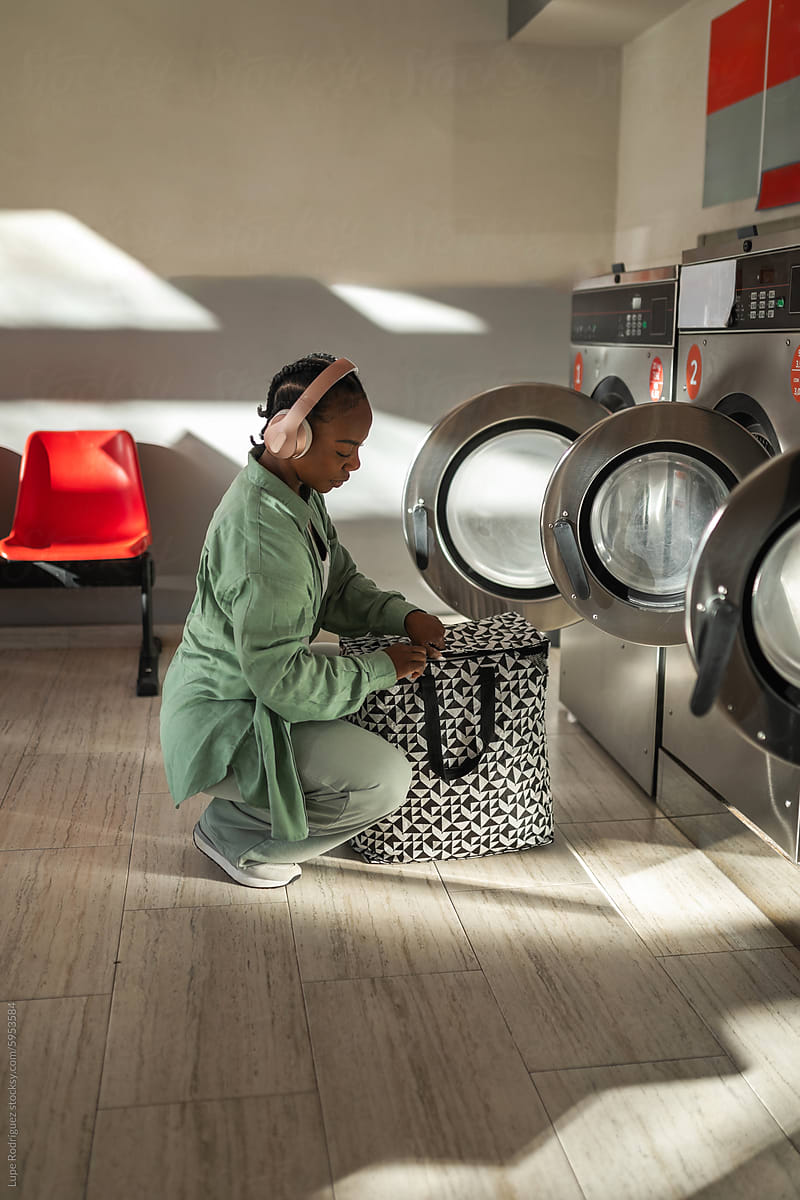 black woman doing laundry in the laundry