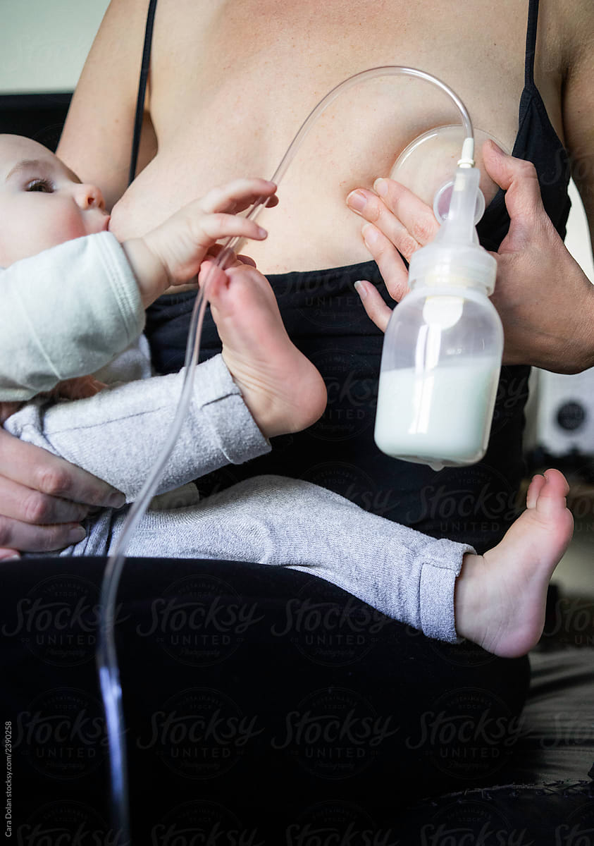 Mother Pumps Milk While Breastfeeding Her Baby