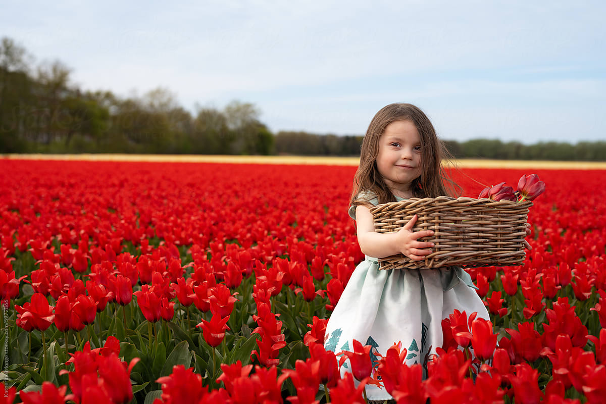 Little girl holding tulip basket