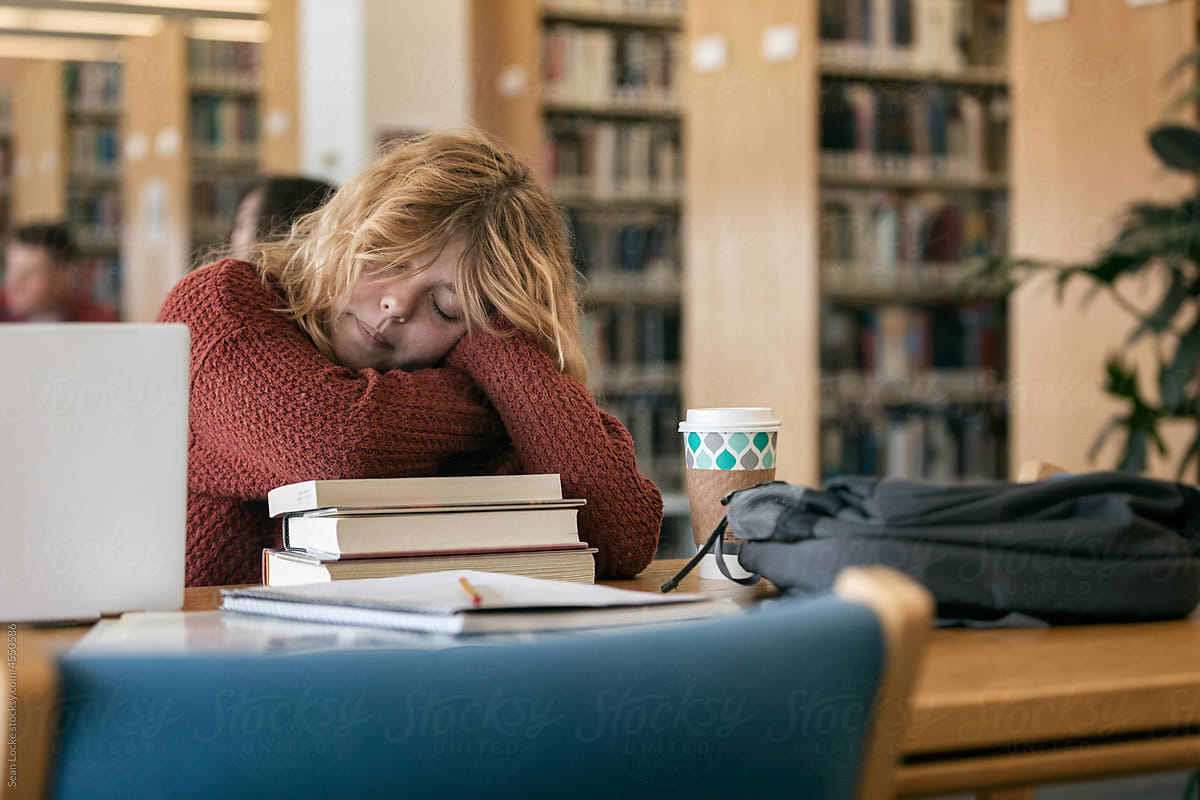 Female College Student Falls Asleep In Library