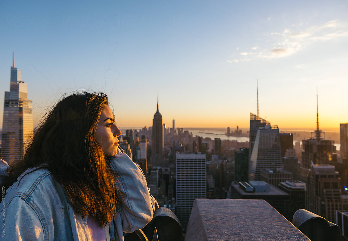 Woman on a skyscraper in New York at sunset