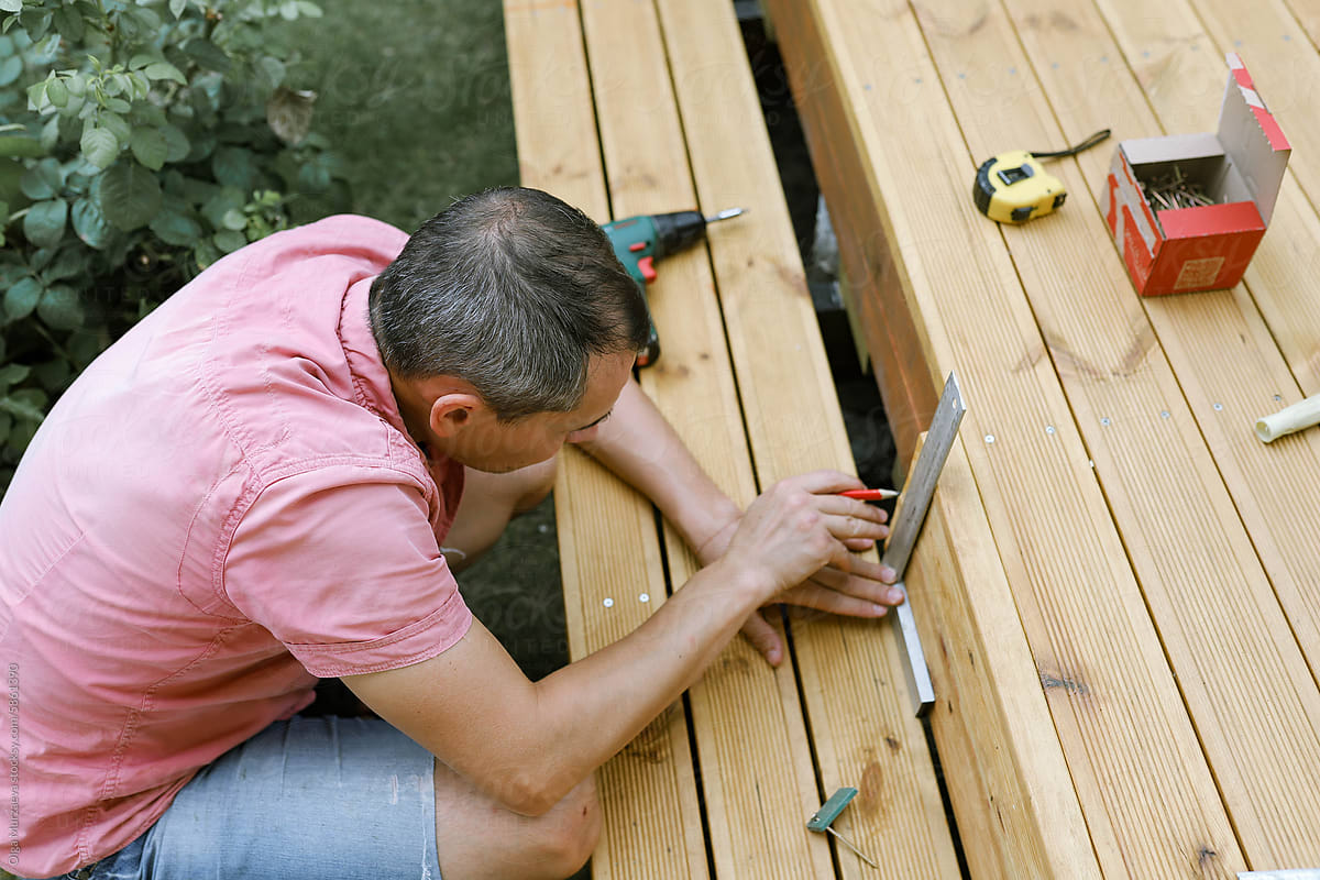 a man makes a terrace in the yard