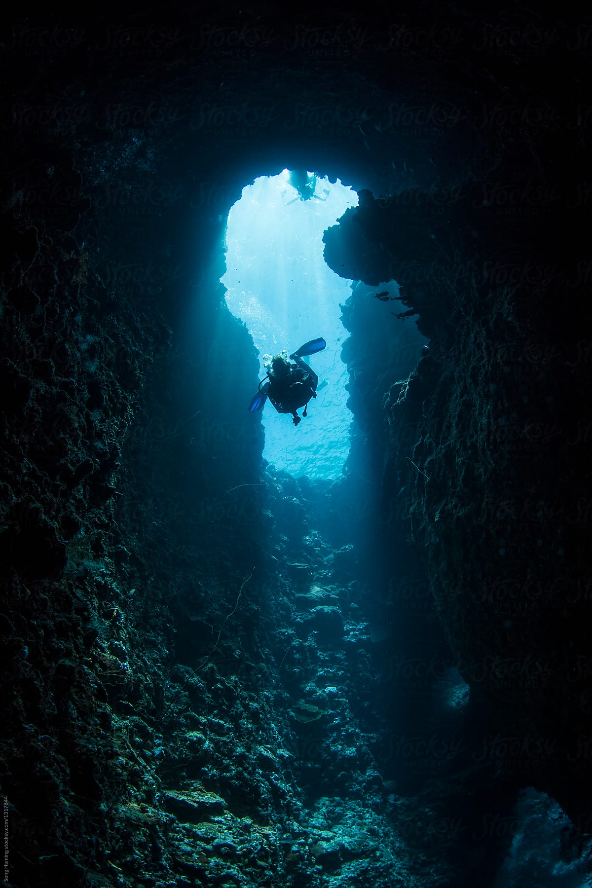 Scuba diver diving down to the blue hole