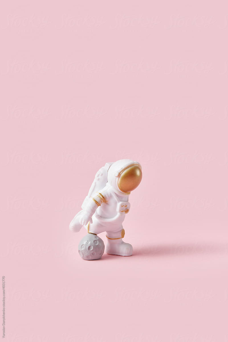 Cosmonaut using moon for playing football