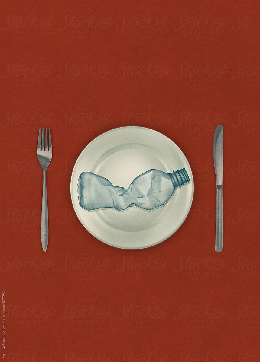 Crumpled plastic bottle on plate on red background
