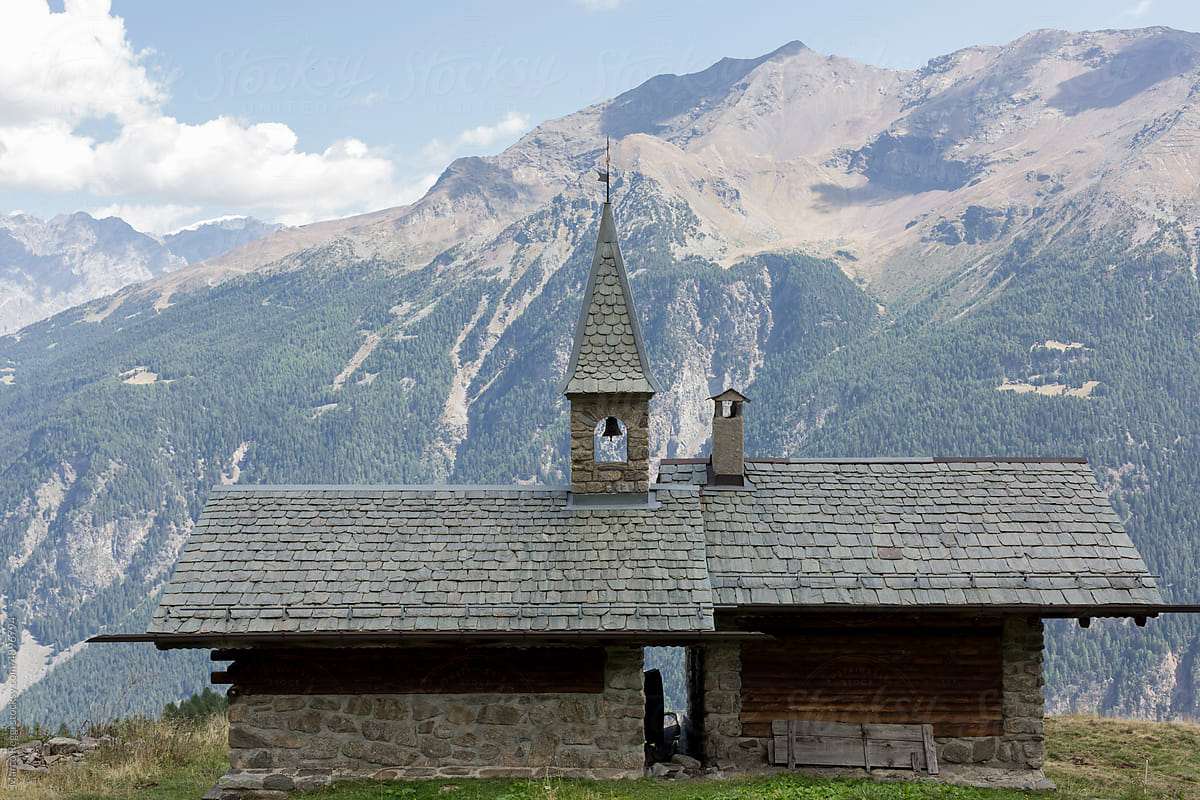 old stone church with mountainous landscape