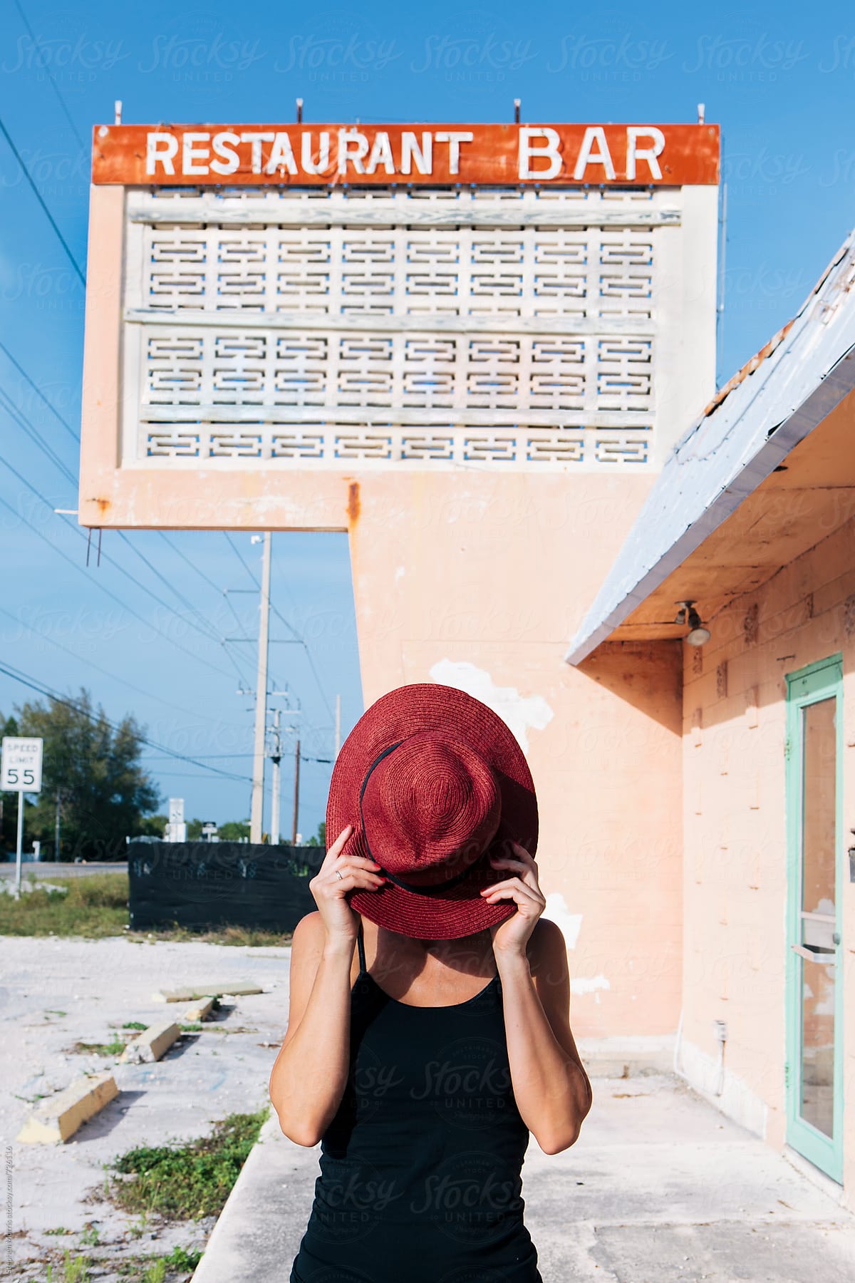Woman in front of Abandoned Restaurant