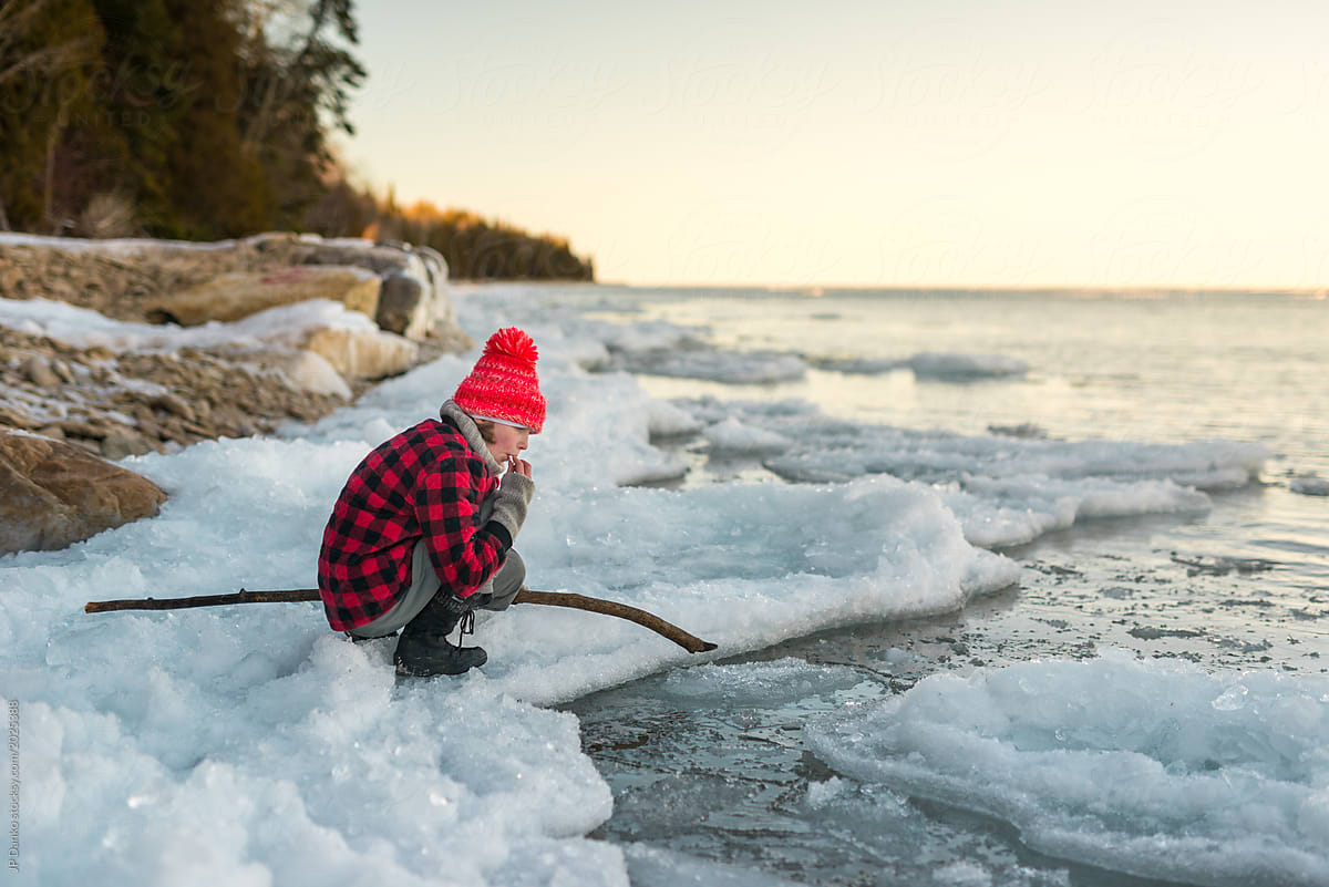 Girl tastes refreshing clean ice from Ontario lake