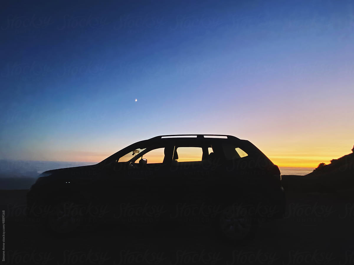 Silhouette of a car at sunset