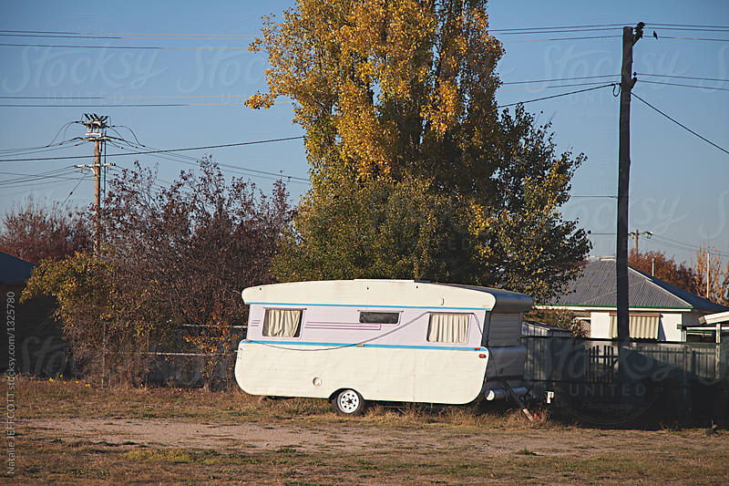 Old caravan parked in paddock in a country town in Australia