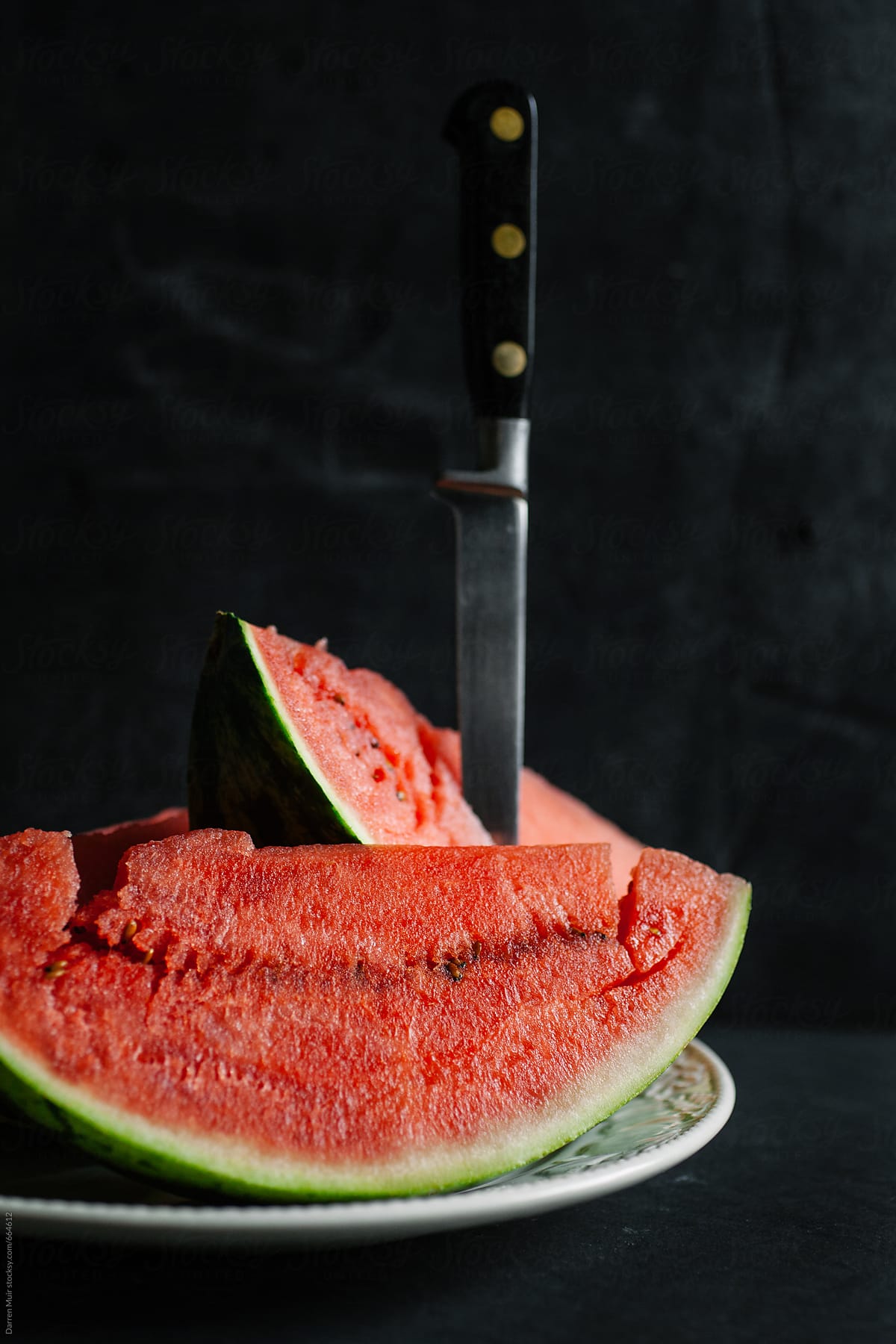 Slices of watermelon in a dark background.