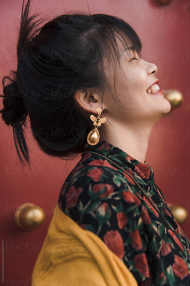 Carefree woman wearing gold jewelry