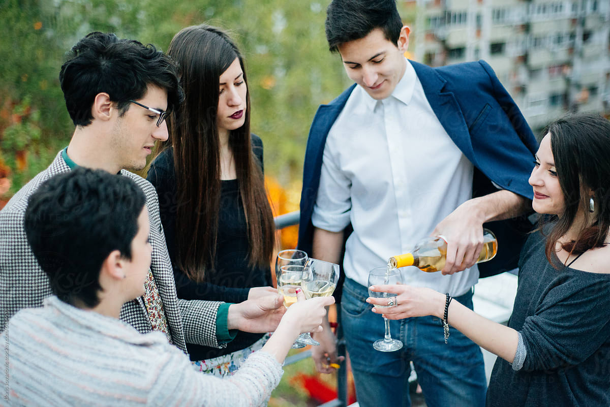 Young people having party and drinking alcohol