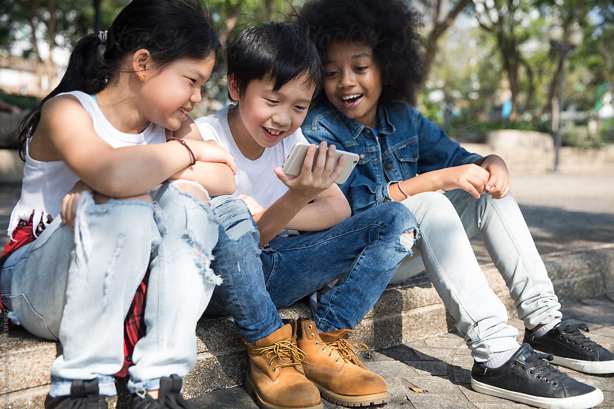Group Of kids Watching looking at smart phone