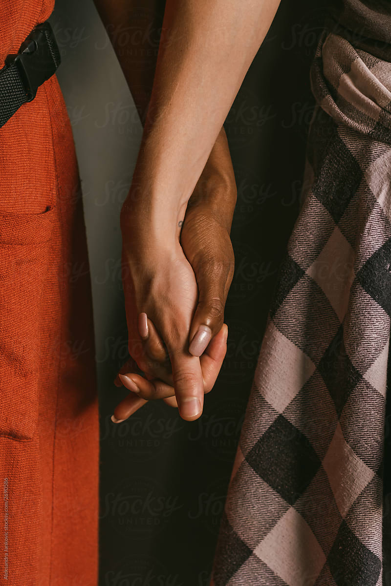 Close Up Of Young Couple Holding Hands