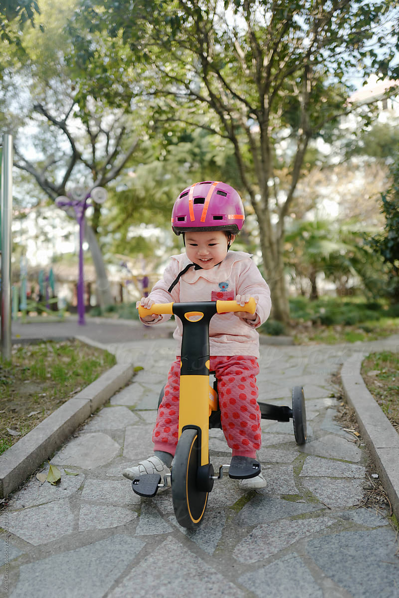 Baby riding tricycle