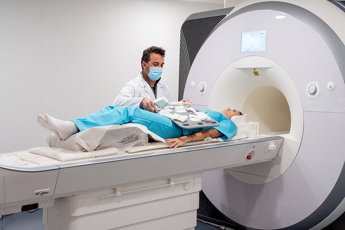 Doctor preparing patient for MRI procedure