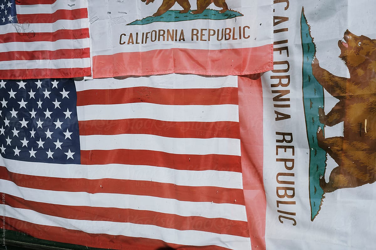 American flags and the flag of California cover a window.