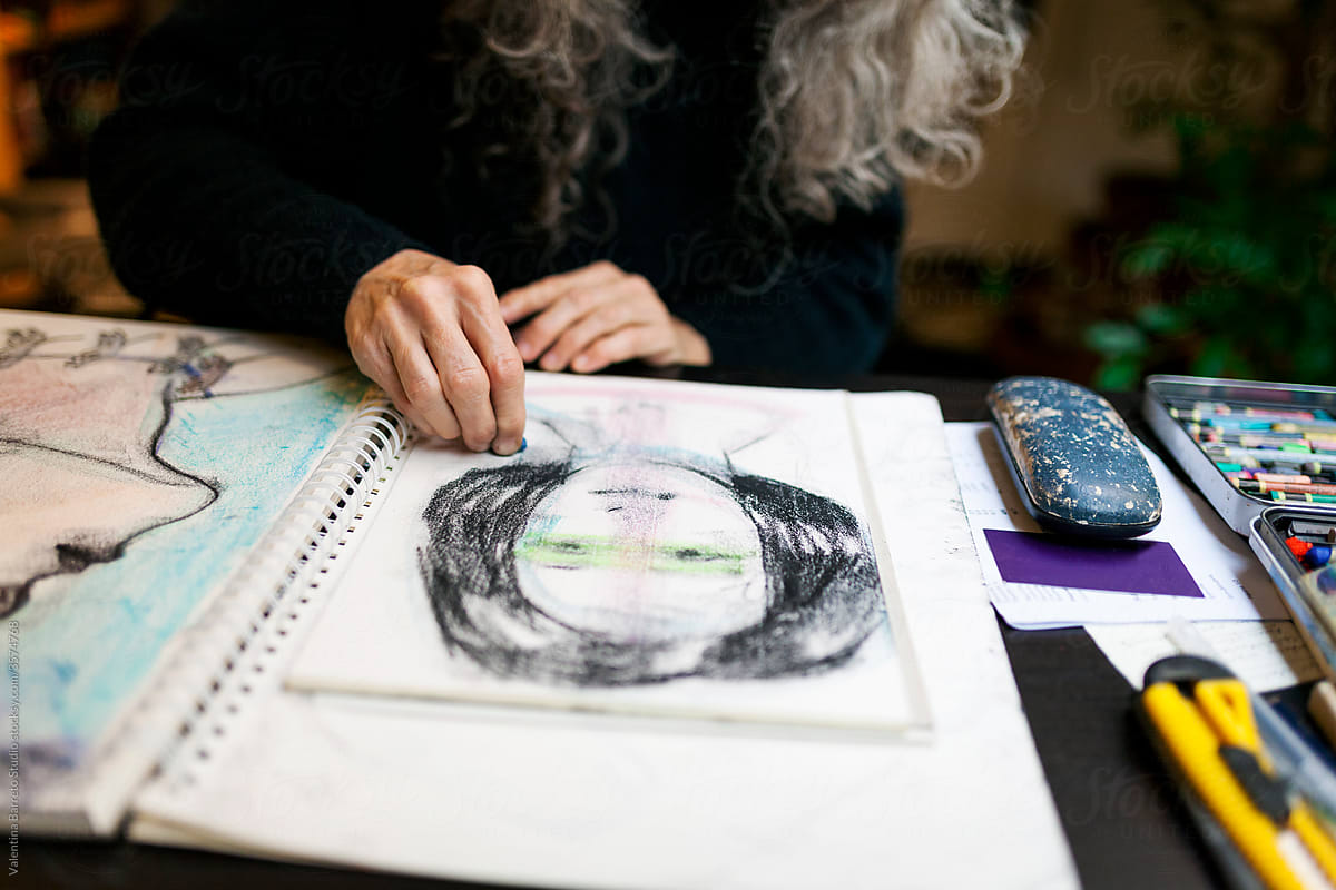 Artist hand drawing a portrait