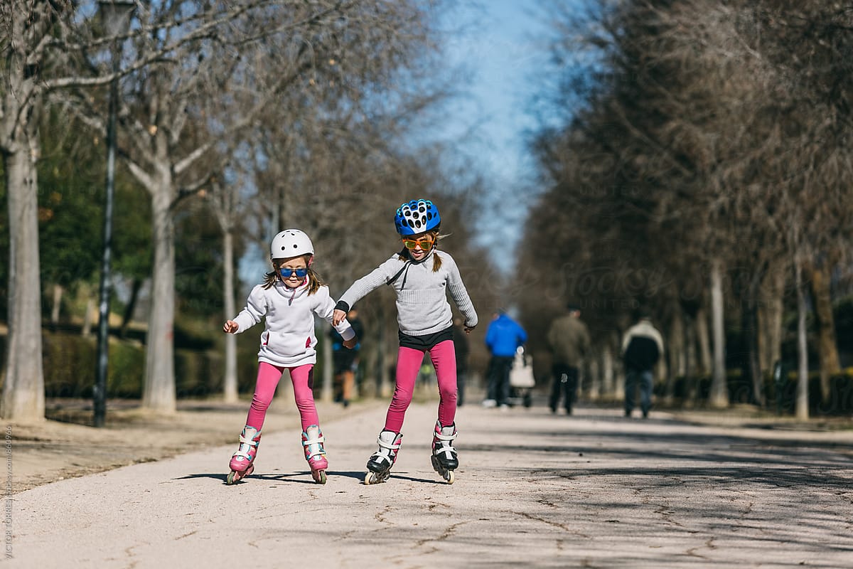 Two Sisters Roller Skating in the Park