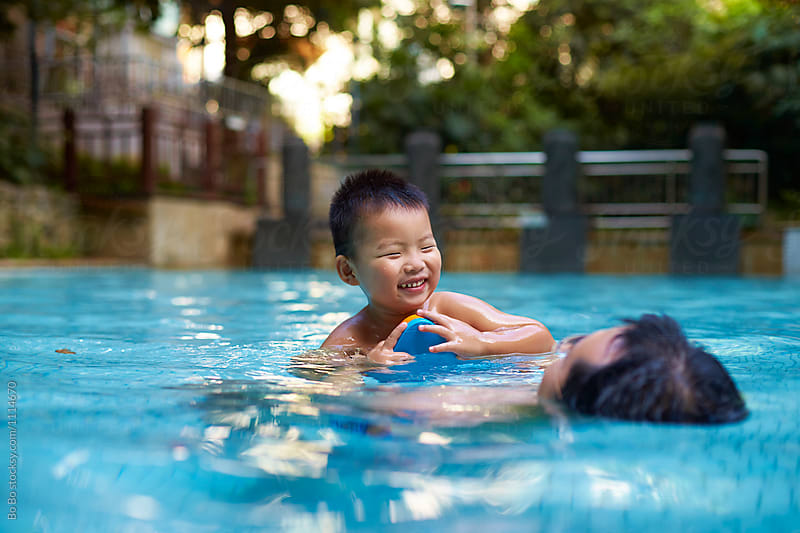 father with his son in swimming pool