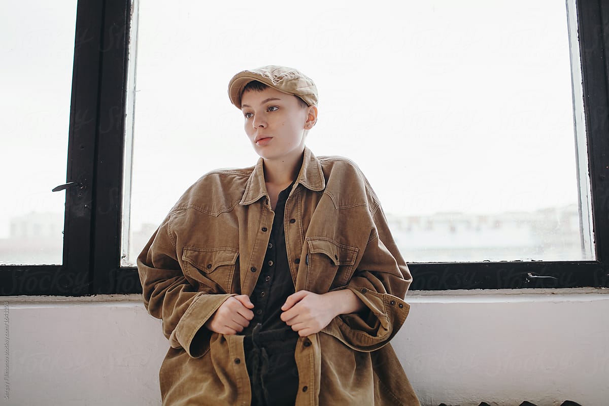 Fashionable woman in cap and jacket