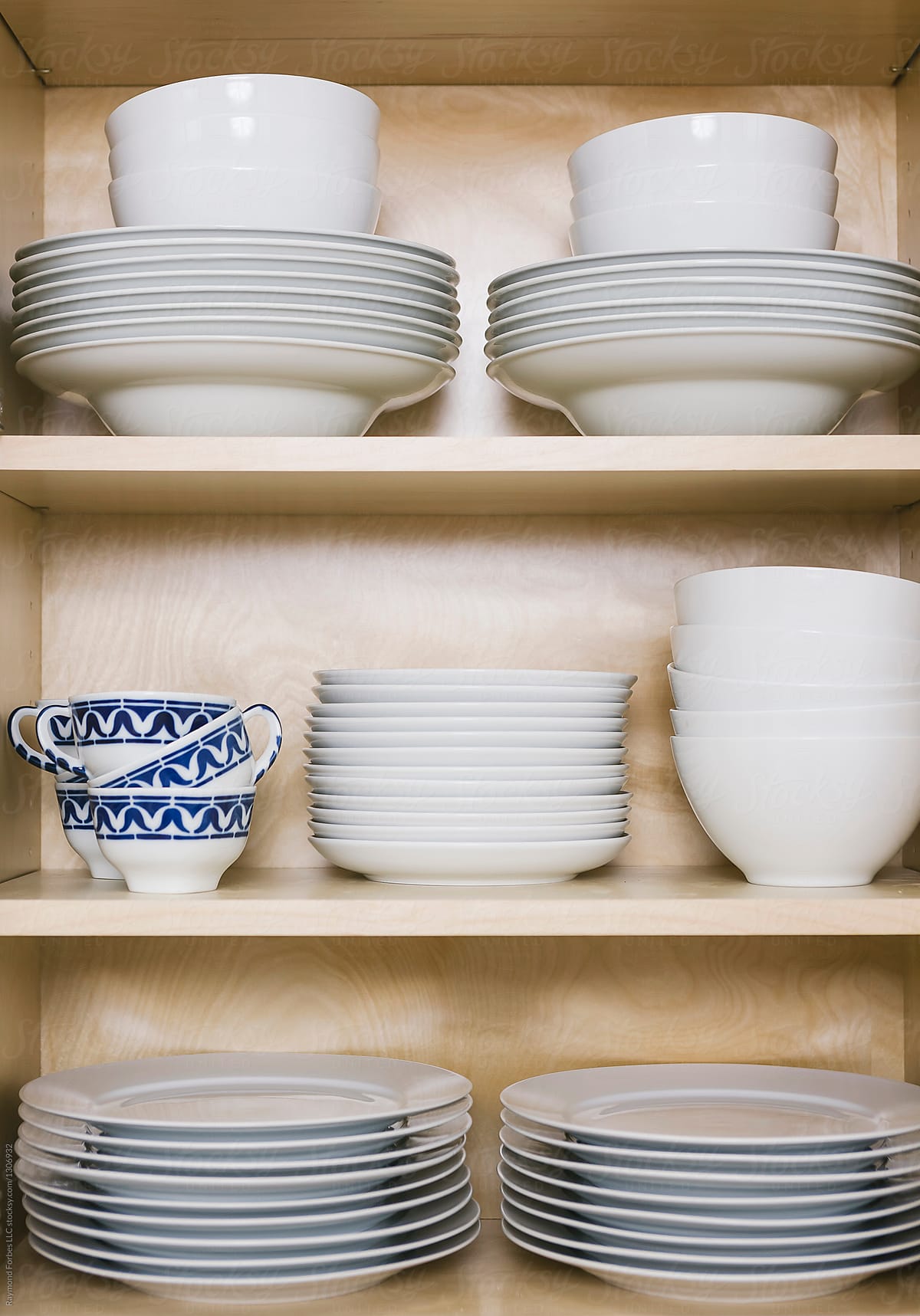 Kitchen Cabinet in home filled with dishes and bowls and plates
