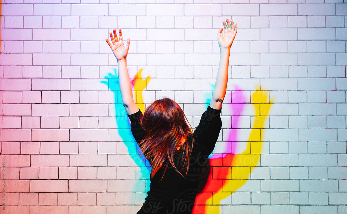 Woman Dancing Under Colored Lights By Stocksy Contributor Michela