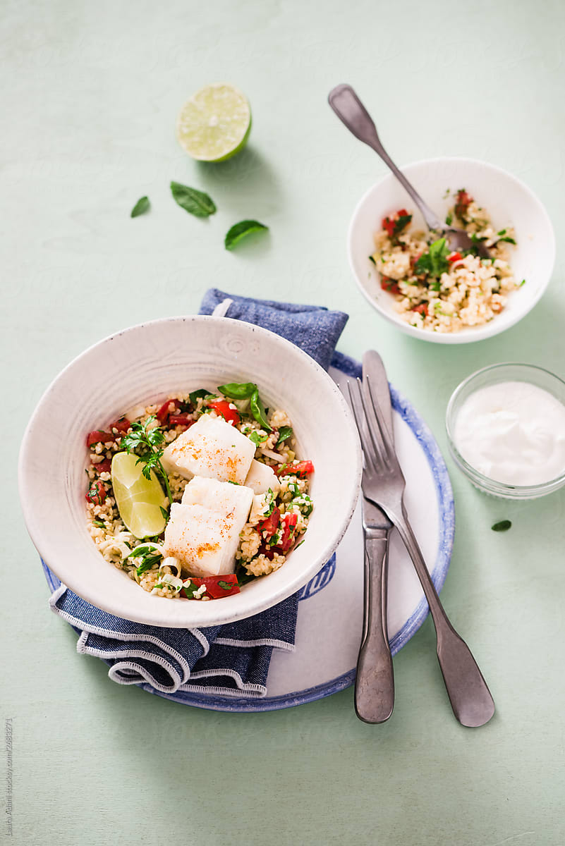 Couscous salad with herbs, tomatoes and cod fillet