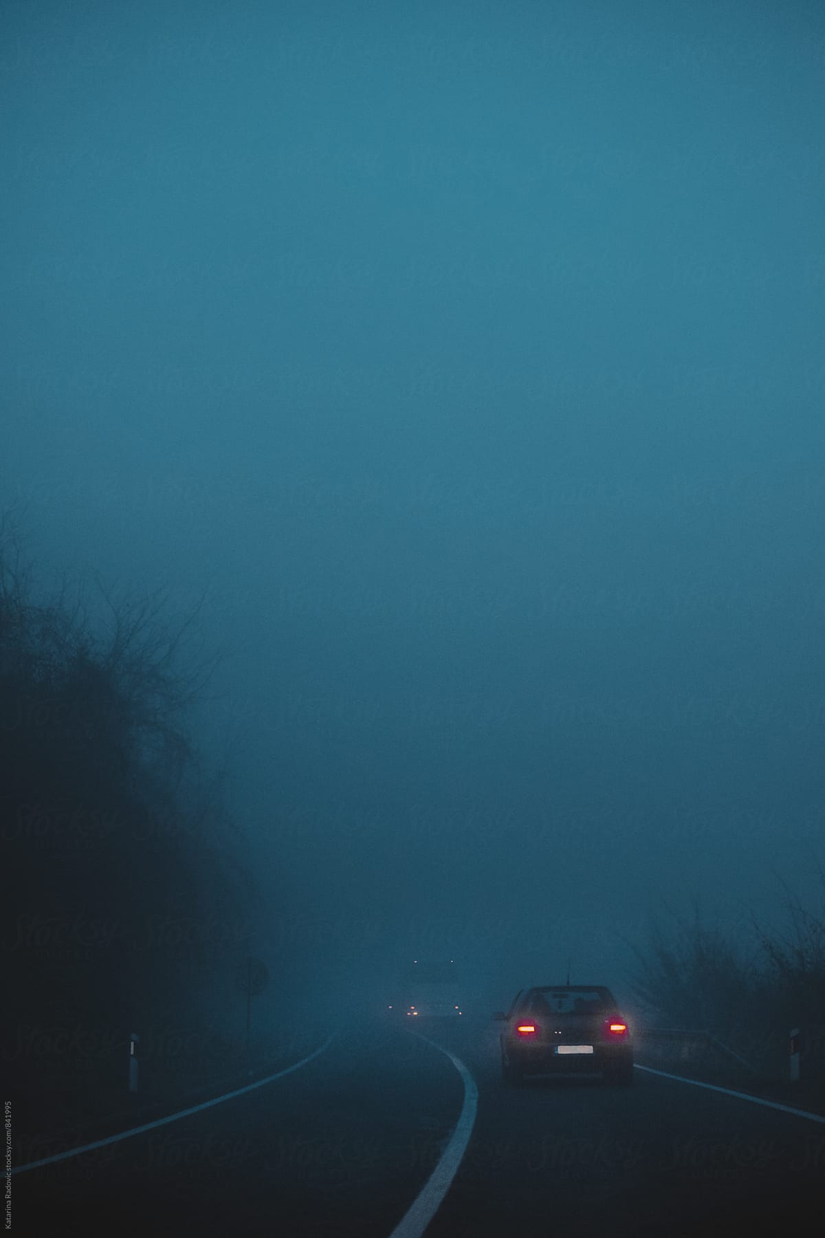 Car on the Road in a Dark Blue Night