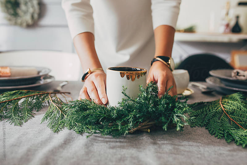 Woman Decorating Table for Christmas Dinner