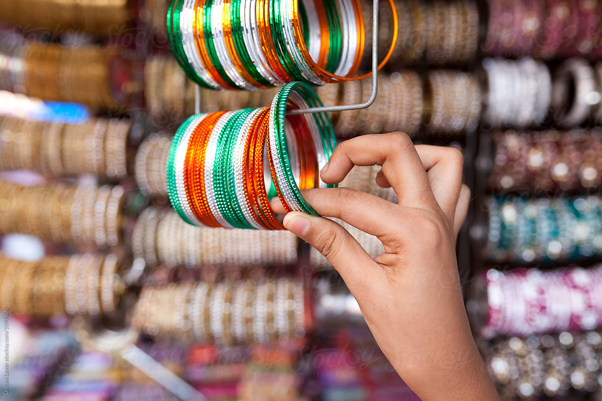 Teenage girl holding colorful bangles