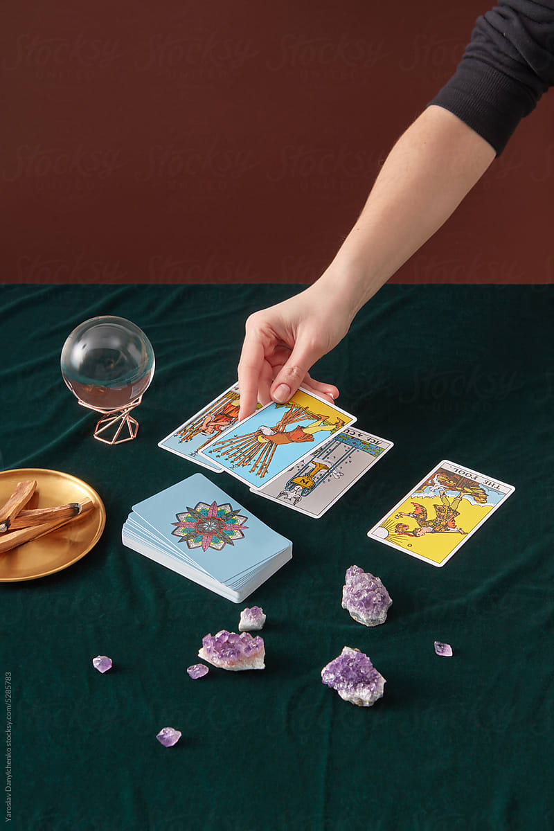 Female medium laying out tarot cards.