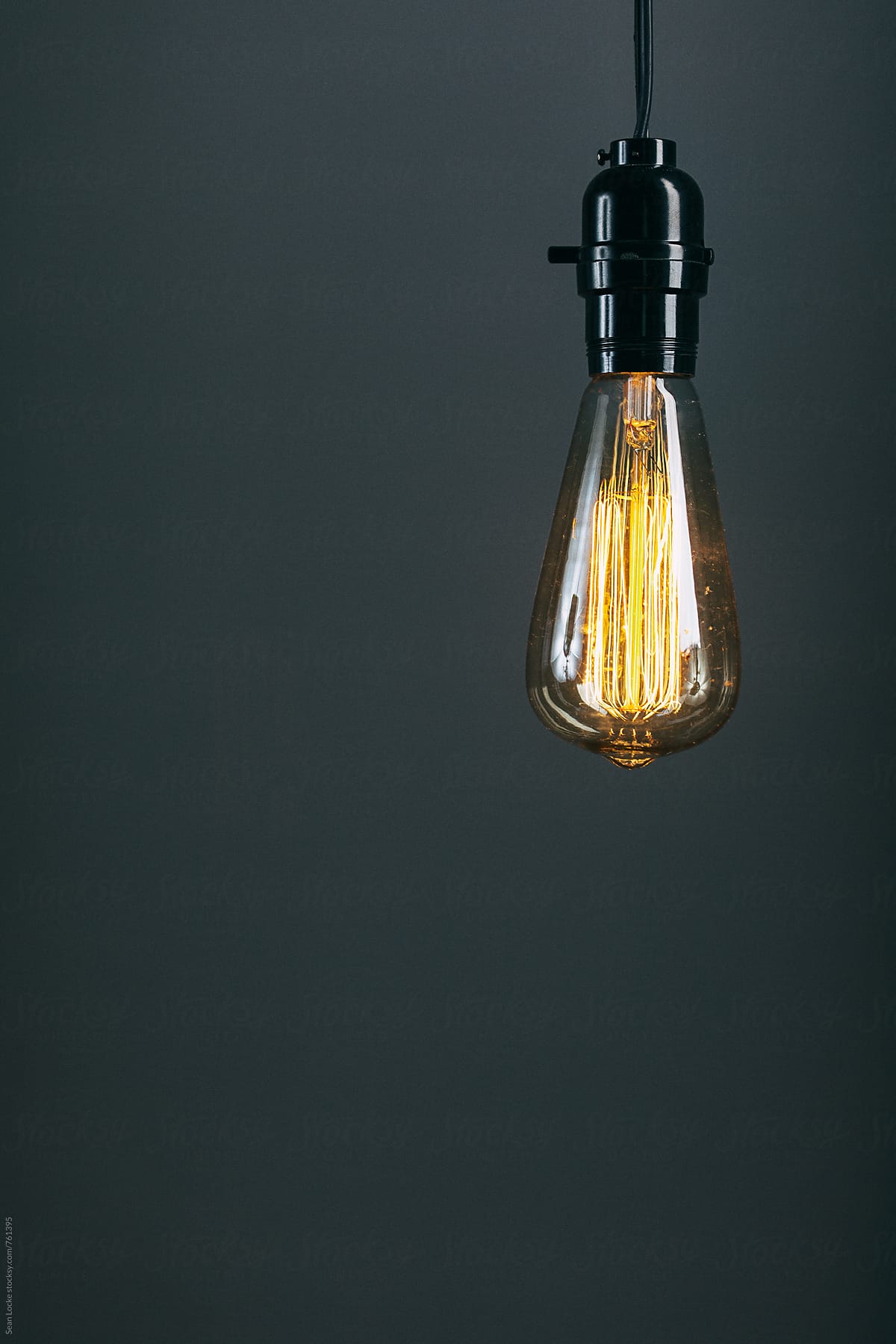 Light: Antique Bulb Hangs In Front Of Blank Wall