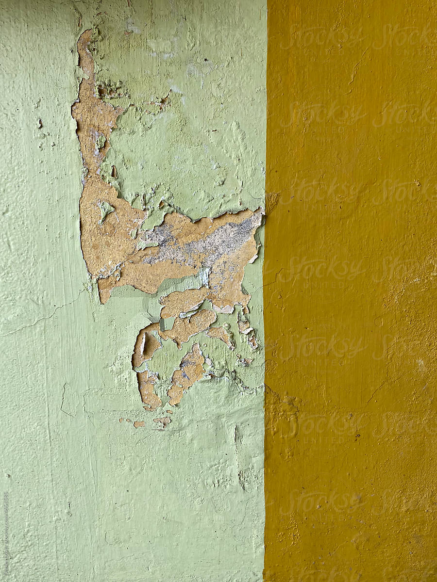 Worn out colour on cemented wall with dual colour