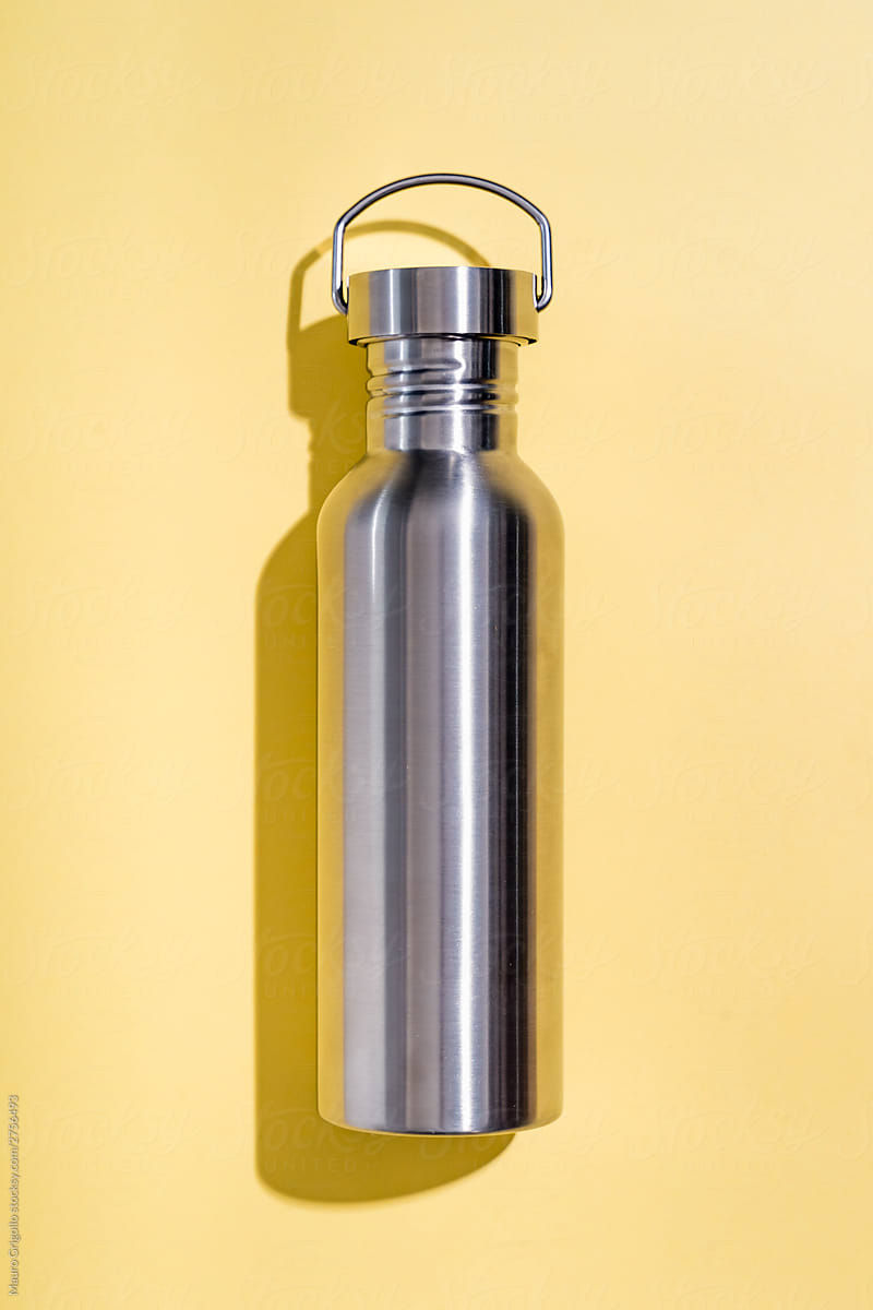 Steel water bottle on a yellow background