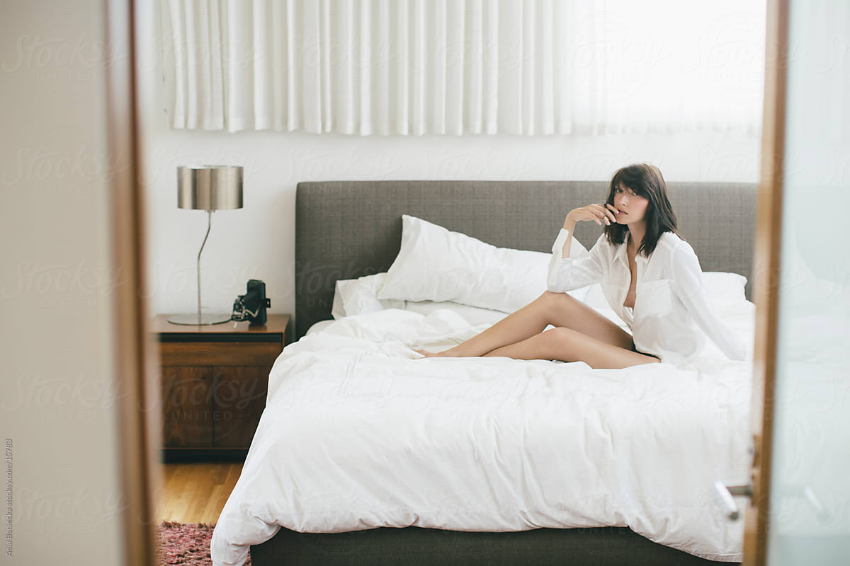 A Candid Portrait Of A Woman Sitting On A Bed By Stocksy Contributor