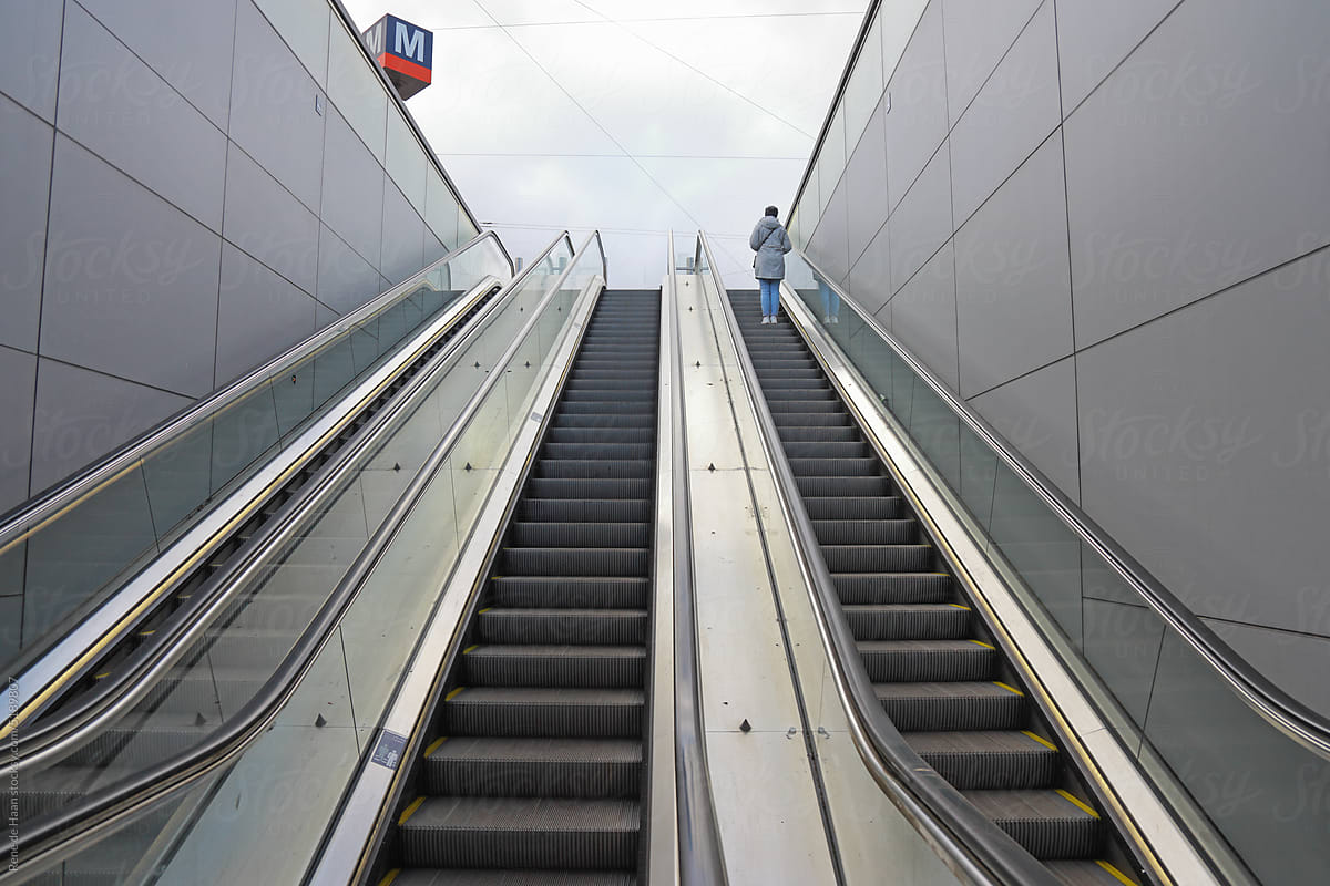 person going upwards on escalator