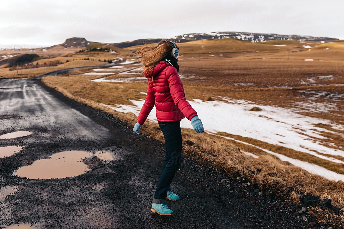 Anonymous woman in a windy winter road
