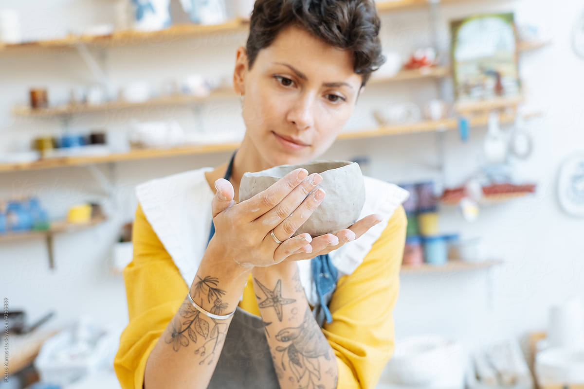 Ceramist woman working with clay at studio