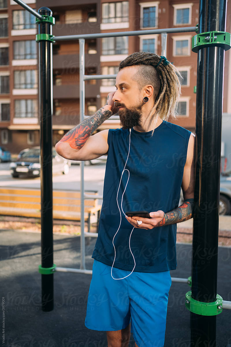 Informal young man  listening to music on workout