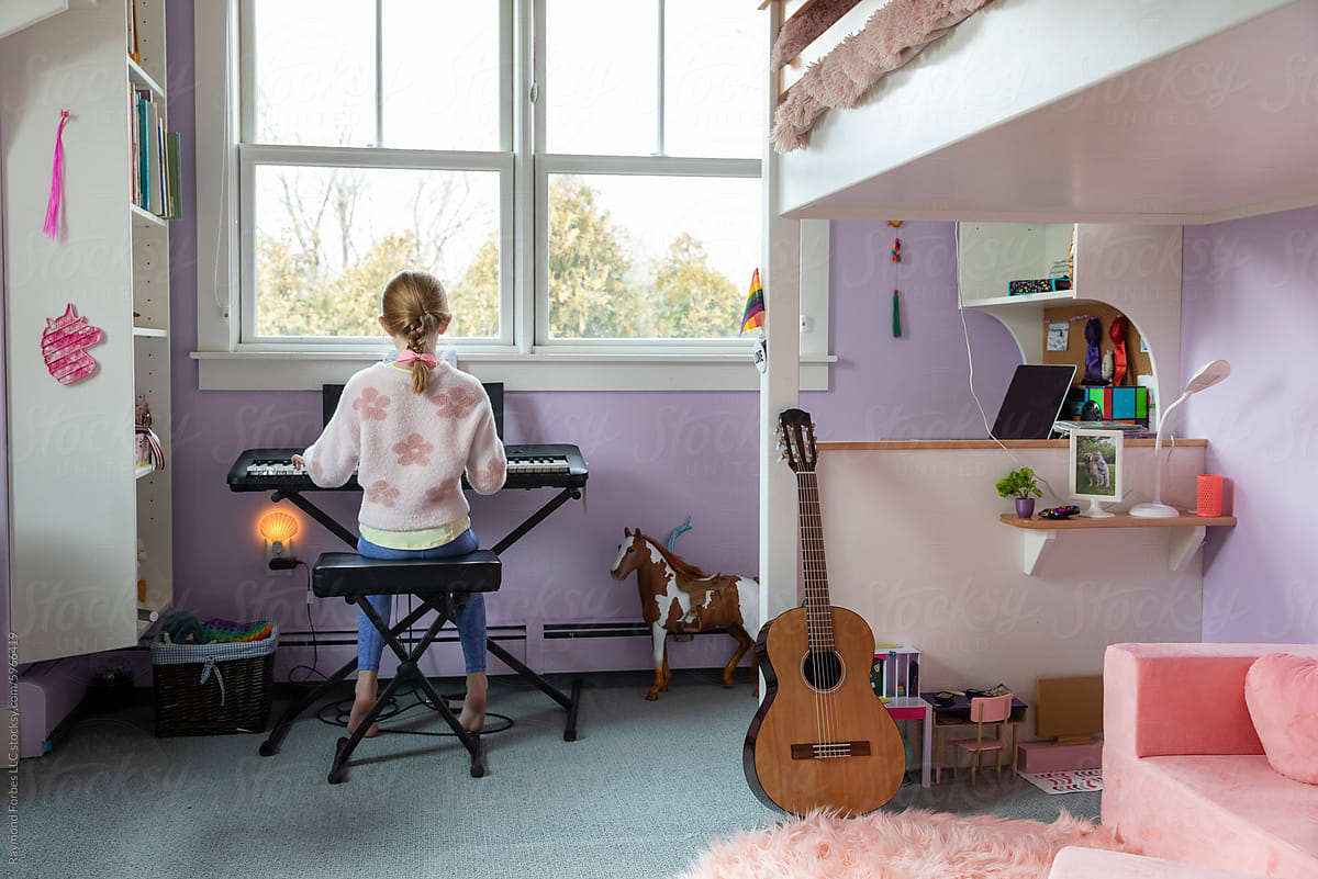 Bedroom interior  house with young girl Playing keyboard piano