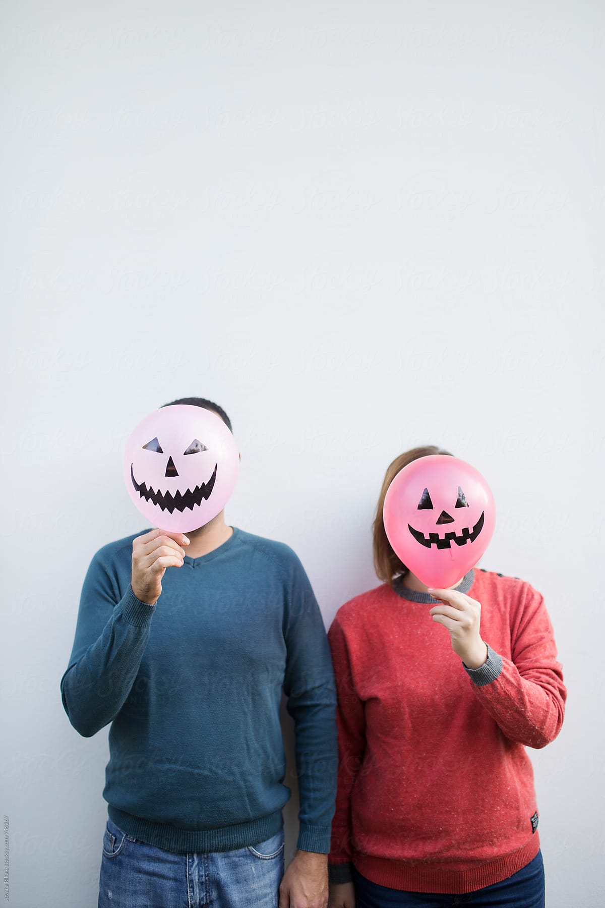 Couple is hiding behind a halloween balloon