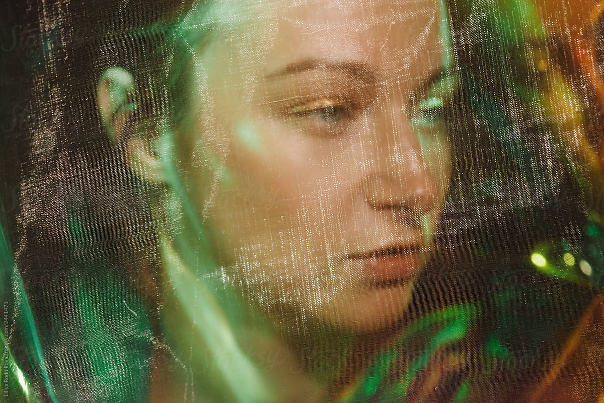 Surreal headshot portrait of young woman in unusual lightning